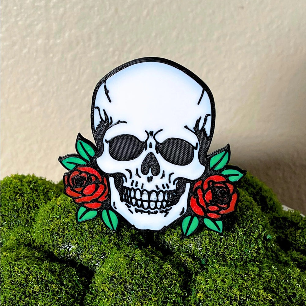 Gothic skull head with red roses on each side shown in a moss houseplant