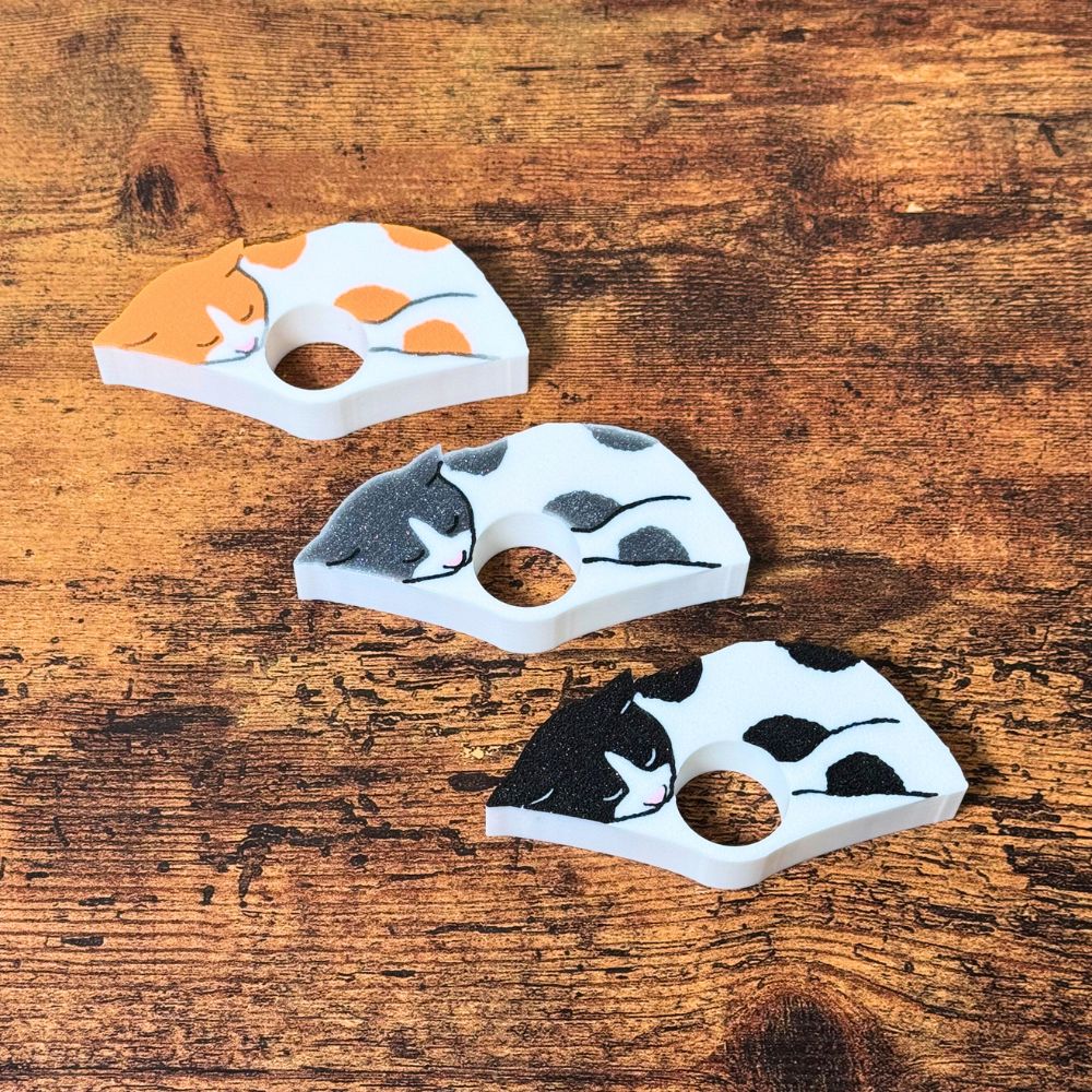 The front of the spotted cat page holders on a wooden table from the top view