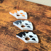 The front of the spotted cat page holders on a wooden table from the side view
