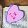Sweet pink bookmark heart that reads Be Mine inside a open book