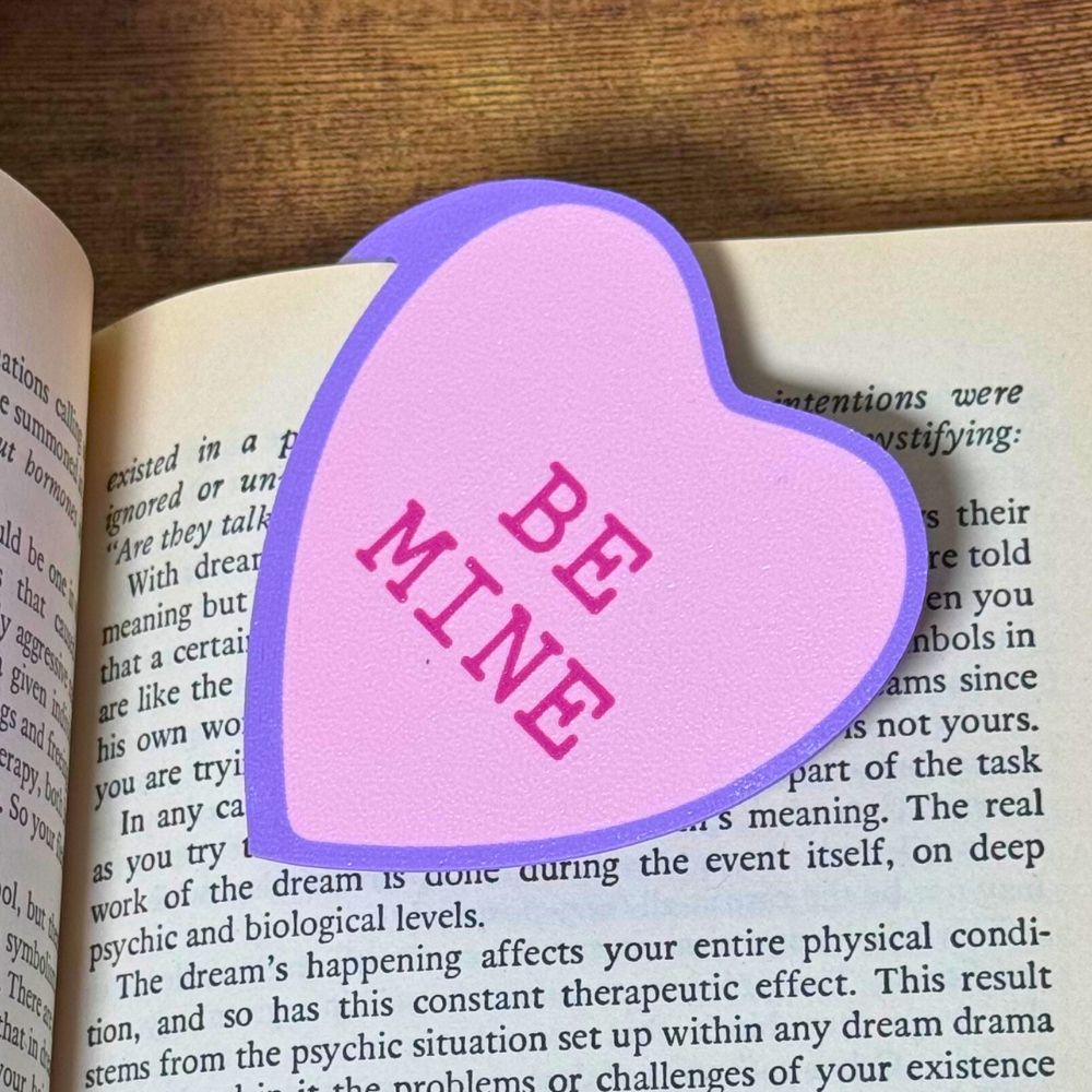 Sweet pink bookmark heart that reads Be Mine inside a open book