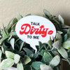 The punny Talk Dirty to Me plant stake in a houseplant closer up