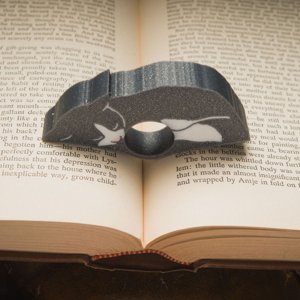 Close up of the gray tuxedo cat page holder
