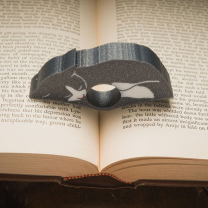 Close up of the gray tuxedo cat page holder