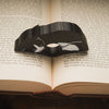 Close up of the black tuxedo cat page holder