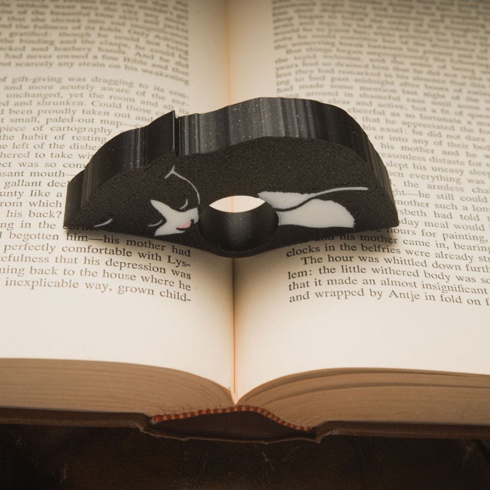 Close up of the black tuxedo cat page holder