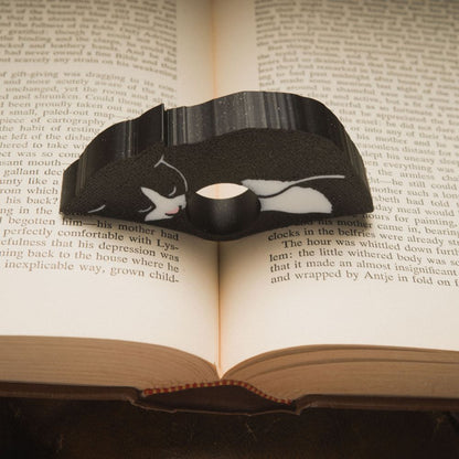 Close up of the black tuxedo cat page holder