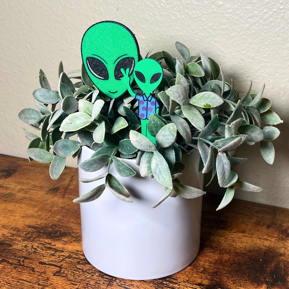 Fun alien plant stakes shown in a houseplant