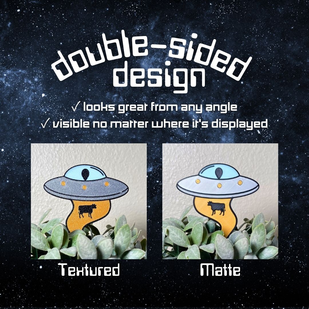 2 UFO Plant stakes with alien inside using it's golden beam to pull up a cow. Picture to highlight the double-sided design, one side Textured and the other Matte